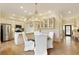 Elegant dining area with a stylish chandelier, seamlessly connected to the modern kitchen at 1950 Buford Dam Rd # 105, Cumming, GA 30041