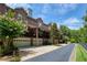 Townhome exterior showcasing brick facade, garages, balconies, and mature trees at 1950 Buford Dam Rd # 105, Cumming, GA 30041