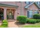 Brick facade of townhome with manicured shrubs, brick walkway and glass front door at 1950 Buford Dam Rd # 105, Cumming, GA 30041