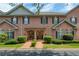 Charming brick townhome exterior featuring well-manicured landscaping and inviting front entrances at 1950 Buford Dam Rd # 105, Cumming, GA 30041