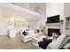 Bright living room featuring a fireplace, hardwood floors, and soaring high ceilings at 1950 Buford Dam Rd # 105, Cumming, GA 30041