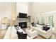 Bright living room featuring soaring ceilings, fireplace, and white sofas with designer pillows at 1950 Buford Dam Rd # 105, Cumming, GA 30041