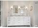 Bathroom showcasing double vanity with two sinks, marble countertop, and bright vanity lighting at 126 Ridgeland Ne Way, Atlanta, GA 30305