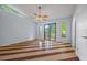 Sunlit bedroom featuring hardwood floors, ceiling fan and windows overlooking the yard at 2557 Wagon Wheel Trce, Duluth, GA 30096