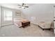 Comfortable bedroom with soft carpet, ceiling fan, and reading chair at 8007 Wishaw Ct, Douglasville, GA 30187