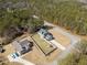An aerial view shows two fenced properties with manicured lawns and bordered by a lush forest at 8007 Wishaw Ct, Winston, GA 30187