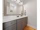 Modern bathroom featuring a large mirror, gray cabinetry, and elegant hardware at 8007 Wishaw Ct, Winston, GA 30187