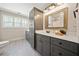 Bathroom featuring a long vanity with storage and a large mirror at 8007 Wishaw Ct, Winston, GA 30187