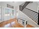 Inviting foyer with natural light, hardwood floors and a built-in dog crate at 8007 Wishaw Ct, Winston, GA 30187