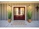 Elegant double front doors with a stylish rug and decorative plants create a welcoming entrance at 8007 Wishaw Ct, Winston, GA 30187