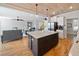 Open concept kitchen with island, stainless appliances, and hardwood floors, perfect for entertaining at 8007 Wishaw Ct, Winston, GA 30187