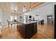 Kitchen with a large island, hardwood floors, and modern lighting fixtures open to living spaces at 8007 Wishaw Ct, Winston, GA 30187