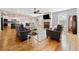 Open-concept living room with hardwood floors, fireplace, and seamless flow to the kitchen at 8007 Wishaw Ct, Winston, GA 30187