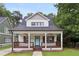 Charming home featuring a welcoming porch, light blue front door, and stylish dark wood shutters at 257 Birch St, Atlanta, GA 30354