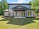 Large backyard featuring a covered patio with an outdoor ceiling fan, ideal for entertaining at 110 Jackson St, Buford, GA 30518