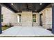 View of the outdoor covered patio with ceiling fan and brick walls at 110 Jackson St, Buford, GA 30518