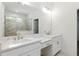 Bathroom with double vanity, white cabinets, light countertops and shower with tiled wall at 110 Jackson St, Buford, GA 30518