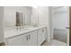 Well-lit bathroom with double sinks, white cabinets, and modern fixtures, offering both style and functionality at 110 Jackson St, Buford, GA 30518