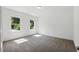 Inviting bedroom filled with natural light from two windows, complemented by neutral carpet and fresh white walls at 110 Jackson St, Buford, GA 30518