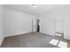 Bright bedroom features neutral carpet, white walls, and easy access to a walk-in closet at 110 Jackson St, Buford, GA 30518