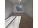 Bedroom with a window letting in natural light and unfinished flooring at 110 Jackson St, Buford, GA 30518