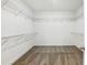 A carpeted walk-in closet with metal shelving offers plenty of space for storage at 110 Jackson St, Buford, GA 30518