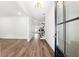 Bright entryway featuring wood-look flooring, chandelier lighting and modern glass door at 110 Jackson St, Buford, GA 30518