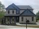 Charming two-story brick home with blue accents and a well-manicured lawn at 110 Jackson St, Buford, GA 30518