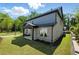 New construction with a brick facade and blue siding, complemented by a well-maintained lawn and landscaping at 110 Jackson St, Buford, GA 30518