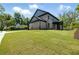 View of the side exterior of the house with large lawn at 110 Jackson St, Buford, GA 30518