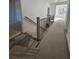 Hallway featuring wood and black metal railing and tan paper covering floors at 110 Jackson St, Buford, GA 30518