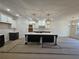 Kitchen featuring a large island, modern light fixtures and neutral color palette at 110 Jackson St, Buford, GA 30518