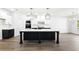 Bright kitchen with white cabinets, black island, stainless appliances, and modern pendant lighting at 110 Jackson St, Buford, GA 30518