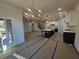 Open floor plan showcasing the kitchen with black island, stainless appliances, and eat in dining area at 110 Jackson St, Buford, GA 30518