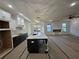Modern kitchen with quartz countertops, white cabinets and an open layout to the living room at 110 Jackson St, Buford, GA 30518