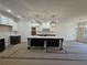Spacious kitchen featuring a large island, white cabinets and luxury pendant lighting at 110 Jackson St, Buford, GA 30518