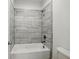 Modern tub shower with gray-toned tiling and fixtures, designed for relaxation and convenience at 110 Jackson St, Buford, GA 30518