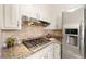 Modern kitchen featuring stainless steel appliances, granite countertops, and ample storage space at 1105 Orchard Way, Roswell, GA 30075