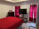 This bedroom features a large bed and a flat-screen television for entertainment at 2270 Exchange Se Pl, Conyers, GA 30013