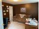 Dark bedroom with couch and dark furniture, adorned with pictures and diplomas at 2270 Exchange Se Pl, Conyers, GA 30013