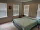 Bedroom featuring two large windows with blinds and decorative painting at 2270 Exchange Se Pl, Conyers, GA 30013