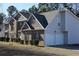 Side view of two-story brick and siding home with a two car garage and manicured bushes at 2270 Exchange Se Pl, Conyers, GA 30013