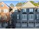 Charming townhouse exterior with painted brick and siding, featuring attached garages and multiple windows at 2406 St Davids Sq, Kennesaw, GA 30152