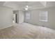 Spacious bedroom with soft carpet, a tray ceiling with fan, and large windows with natural light at 2503 Owens Landing Nw Trl, Kennesaw, GA 30152