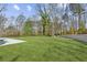 A sprawling backyard features a large manicured lawn, modern pool, and outdoor seating area for luxurious outdoor living at 1297 Swims Valley Nw Dr, Atlanta, GA 30327