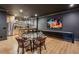 Open basement features a seating area, dining table, and wet bar with a mirrored backsplash at 1297 Swims Valley Nw Dr, Atlanta, GA 30327