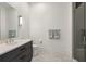 Sleek bathroom featuring a gray vanity with a marble countertop, herringbone floors and glass shower at 1297 Swims Valley Nw Dr, Atlanta, GA 30327