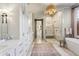 Spa-like bathroom with a marble shower, free-standing tub, and custom vanities at 1297 Swims Valley Nw Dr, Atlanta, GA 30327
