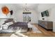 Beautiful bedroom featuring hardwood floors, a gray tufted headboard and modern chandelier at 1297 Swims Valley Nw Dr, Atlanta, GA 30327