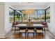 Bright breakfast nook with large windows, custom lighting, and views of the landscaped yard at 1297 Swims Valley Nw Dr, Atlanta, GA 30327